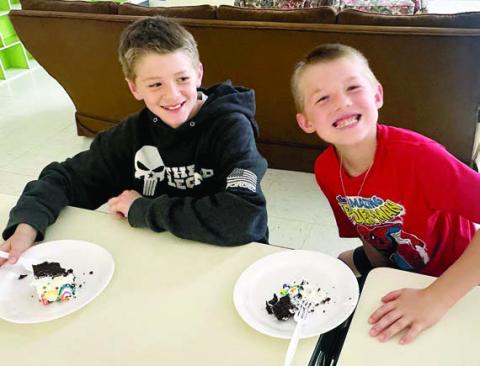 Each month, a generous board member of the Boys &amp; Girls Clubs of Champion Valley donates a cake to honor Club members with birthdays in that month. Shown enjoying a sweet treat are (from left) Camden Spradley and Braxton Spradley.