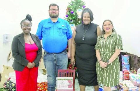BRIDGE board members shown at the “Christmas in July” event include (from left) Rebecca Powe, co-founder and executive director; Jeremy Castleberry; LaToya Ray, co-founder and interim treasurer; and Crystal Flores.