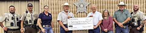 Fayette County Sheriff 's Off ice personnel shown receiving a $2,772.90 grant check from The NRA Foundation and Friends of NRA are (from left) Deputy Herman Olvera, Sgt. Ron Naumann, Sgt. Angela Lala, Sheriff Keith Korenek, Dennis Brower-Friends of NRA, Renee Moreland-FCSO, Lt. David Beyer and Deputy Joe Gonzales.