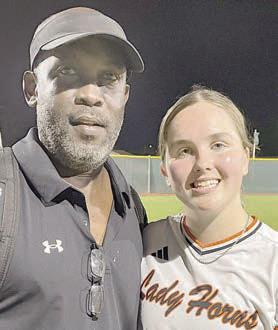 After coaching his final game Friday night, Gilbert Price poses with Haylie Goode, the lone senior on this year’s Lady Horn softball team. Sticker Photo By Darrell Vyvjala