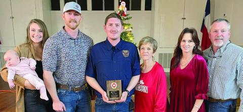 The Schulenburg Volunteer Fire Department’s OUTSTANDING SERVICE AWARD for 2023 went to Dylan Schilhab (center). He made the highest percentage of calls, meetings, and drills at 87 percent. The award is sponsored annually by the family of the late Chief Roland Proske. Making the presentation were: (from right) Jeff, Terry, and Pat Proske, as well as (from left) Kelsey and Doran Proske with their daughter Lace. Sticker Photo By Darrell Vyvjala