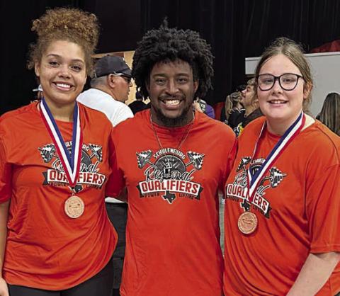 Earning medals at the regional meet were Arianna Vincent ( left) and Cora Brenek (right). They are shown with SHS powerlifting coach Jaylen Samuels.