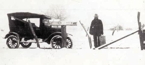 A mail carrier, possibly John Giese, is shown holding a mail bag and pouch after the Jan. 23, 1926, snowfall.