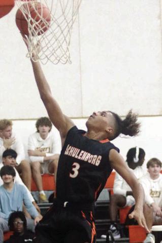 Byron Johnson scores on a fast-break layup in the fourth quarter against Yoakum. Sticker Photo By Darrell Vyvjala 