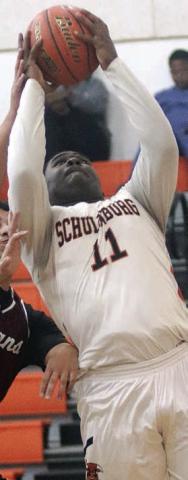 Tavondrick Ellison scores under the basket in the first quarter against Ganado. Sticker Photo By Darrell Vyvjala