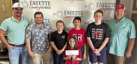 Representatives of Fayette Country Homes and Adamek Rentals LLC, shown with St. Rose students, are (front) Emma Zweschper; (back row, from left) Dalton Friedrich and Dalton Manning, representing Fayette Country Homes; Brody Brossmann, Dylan Zweschper and Bo Brossmann; and Gary Adamek, owner of Fayette Country Homes and Adamek Rentals, LLC