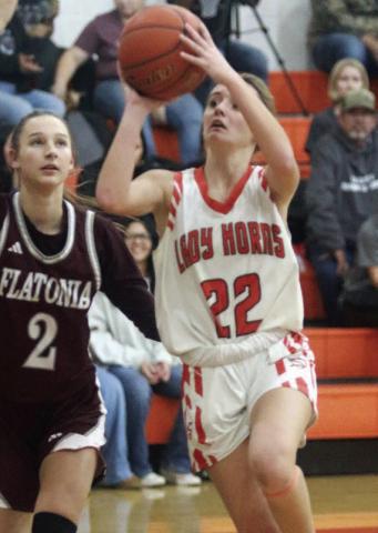 Miranda Bonner drives into the lane past a Lady Bulldog to get off a shot in the first quarter. Sticker Photo By Darrell Vyvjala