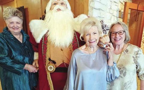 Hostesses for the Garden Club Christmas luncheon were (from left) Patricia Greeson, Santa, Sharon Rankin and Nancy Tinsley.