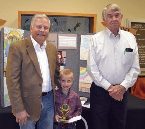POSTE R CONTE ST – Division 1 (Grades K-2) Winners: Carter Ahrens of Flatonia Elementary (center) and Byrlinn Marrs of Flatonia Elementary (not shown) Presenters: Gene Kruppa (left) and Norman Schultz (right) representing Colorado Valley Communications