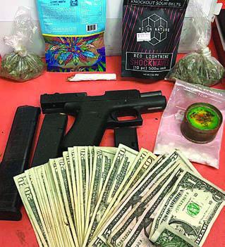 Shown above are the drugs, firearms, and cash recovered by the SPD after a traffic stop that resulted in the arrest of a 25-year-old La Grange man.