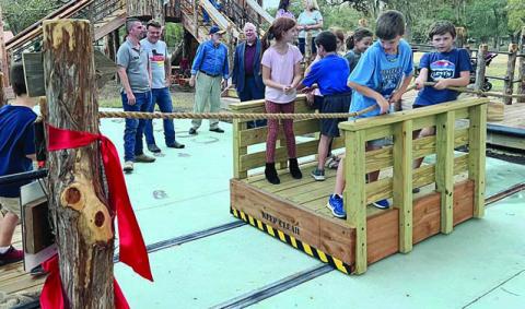 the Kreische ferry is being used by children to cross the “Colorado River” on the educational playscape.
