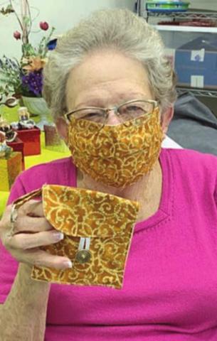 MATCHING MASK &amp; PURSE – Navidad Valley Community Connections member Irene Janda wears a mask and holds the matching purse. The purse is only the size of a folded mask, and attaches to a regular purse, belt or backpack. The matching masks and mini-purses are available by contacting NVCC.