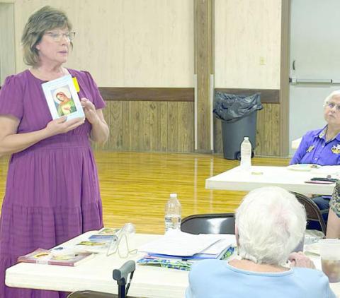 “Flame of Lo ve” was the topic of the program presented by Diane Holub (left) to the Catholic Daughters.