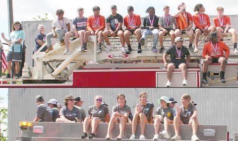 Schulenburg High students who qualified for state or won state titles ride atop Schulenburg Volunteer Fire Department trucks as parade marshals Sunday morning. Sticker Photos By Darrell Vyvjala