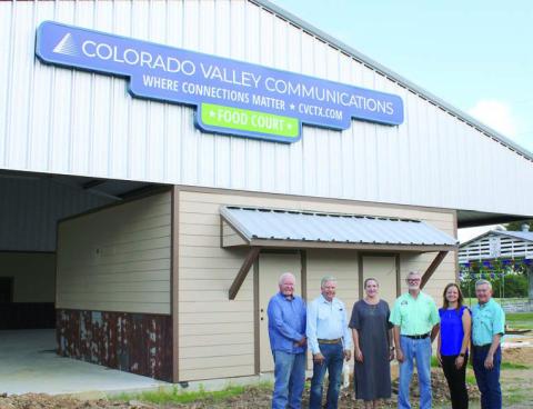 The Fayette County Fair food court now has a sign acknowledging the contributions of Colorado Valley Communications. Shown are (from left) CVCTX representatives John Wied-attorney, Gene Kruppaboard president and Karen Gunkel-director of regulatory affairs and marketing; Michal Zuhn, Fayette County Fair board president; and CVCTX representatives Amber Sternadel-customer relations supervisor and Kelly Allison-General Manager.