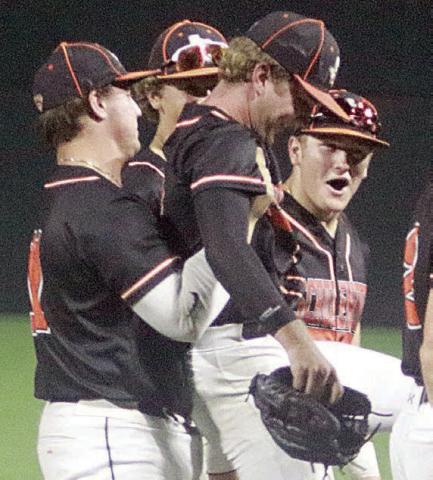 Winning pitcher Brycen Schramek get a hoist from Tyson Wagner as elated teammates surround them following the final out last Friday night. Sticker Photo By Darrell Vyvjala