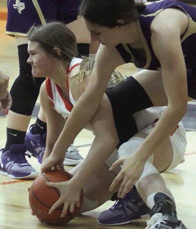 Haylee Vacek battles for a loose ball in the second half of the game against Shiner. Sticker Photo By Darrell Vyvjala