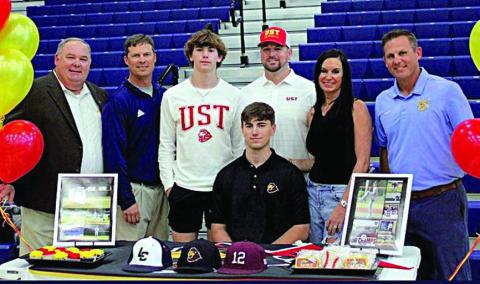 Jaxson Hanel (seated), a senior at Lake Creek High School in Montgomery ISD, signed a letter of intent on Wednesday, Nov. 8 to play baseball for the University of St. Thomas in Houston. Hanel is the grandson of Harlan and Betty Guettermann of Schulenburg. Also shown at the signing are his parents, Lisa and Mark Hanel (second and third from right); his brother Austin (third from left); Lake Creek High School principal Tim Williams (left); and his two coaches (right and second from left).