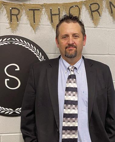 Lee Hartsell poses for a photo in the office he’ll soon occupy as Schulenburg junior high principal. Sticker Photo By Darrell Vyvjala