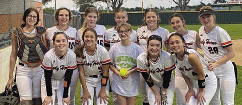 Rylee Robertson threw the first pitch at the Schulenburg vs. Flatonia softball game. She is shown with the Schulenburg softball team.