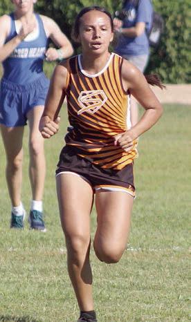 Yasmin Cortez sprints to the finish line to place 13th. Sticker Photo By Darrell Vyvjala