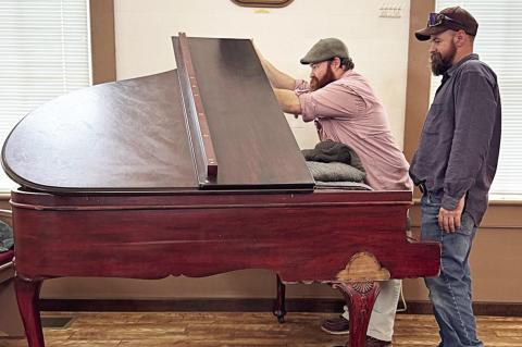 The M. Welte & Sons baby grand piano was delivered and is being tuned and restored by brothers Marquis Burkham and Quinton Burkham (pictured) of Plum Piano Restoration Company of La Grange.
