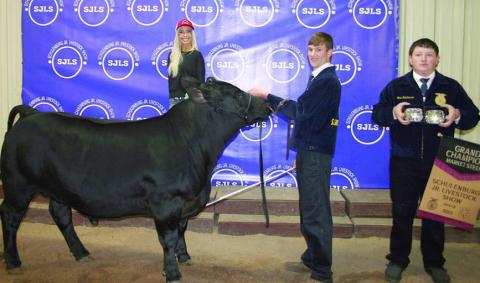 GRAND CHAMPION MARKET STEER – Exhibitor: Grant Kubala (second from right). Sales price: $10,000. Sticker Photo By Darrell Vyvjala