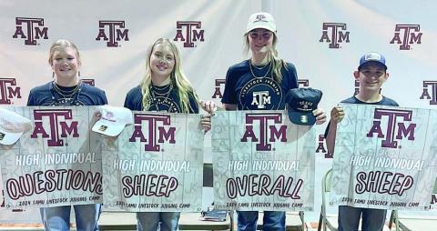 Awards – Holding the award banners are (from left) Haley Schramek, Keeley Warnken, Madyson Holub and Dylan Zweschper.