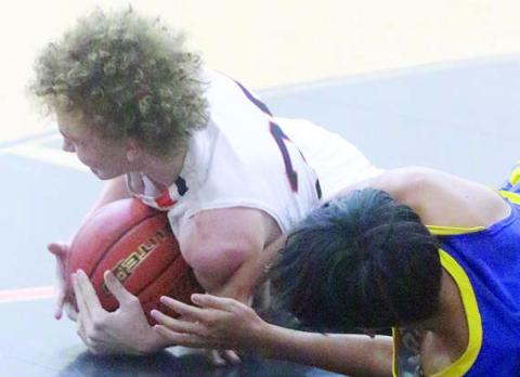 Alton Herzik rips a loose ball away from a Hornet in the second half. Sticker Photo By Darrell Vyvjala