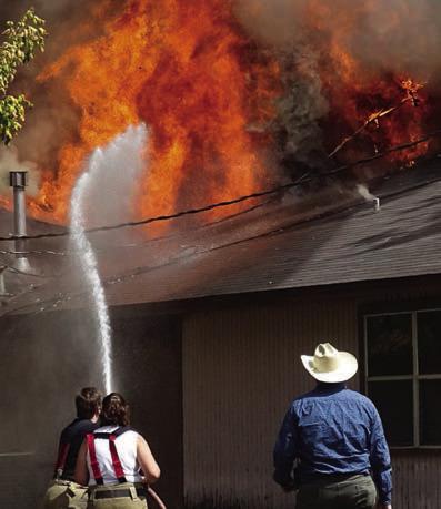 FF&R firefighters Julie Blair (left) and DeDe Eliott (center) work together while Fayette County Emergency Management Coordinator Craig Moreau looks on. Photo By Melanie Berger / Courtesy of Flatonia Argus