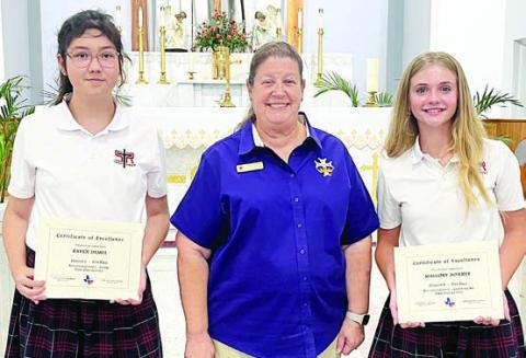 St. Rose of Lima students presented certificates at the end of the school year as first-place winners in the state Catholic Daughters of America Education Contest were Raven Demel (left), Division 1 Poetry, and Mallory Bonner (right), Division 2 Computer Art. Also shown is CDA Regent Grace Lebeda (center).