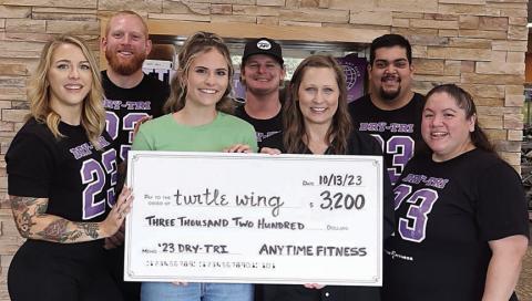 $3,200 check presented – The Dry-Tri held by Anytime Fitness raised $3,200 which was donated to Turtle Wing Foundation. On hand for the check presentation were (front row, from left) Lauren Ralph, Anytime Fitness; Destiny Psencik and DeeAnn Hooper, Turtle Wing Foundation; Amanda Brown, Anytime Fitness; (back) Mitchell Martin Bailey, Reyden Svatek and Abraham Centeno, Anytime Fitness.