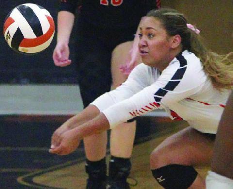 Kieryn Adams lunges to get to a Ladycat attack in game one. Sticker Photo By Darrell Vyvjala