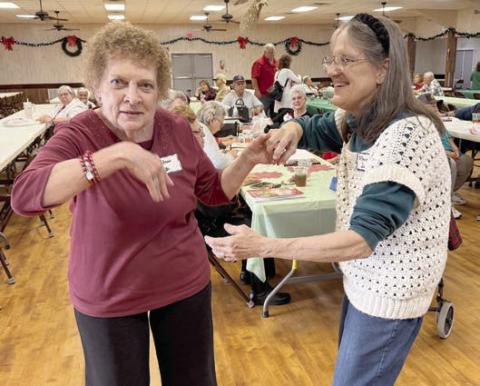 Dancing to the music of Super Dave Hollas are (from left) Janis Kutac and Monica Dunsworth.