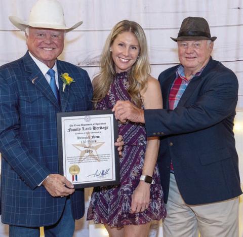 Texas Agriculture Commissioner Sid Miller (left) presents the Family Land Heritage Certificate to Bob Heinrich (right) and his daughter, Stacey Heinrich Smatresk. Also on hand for the award were Bob’s grandchildren Ryker, Barrett, and Sidney Smatresk as well as his son-in-law Erik Smatresk.