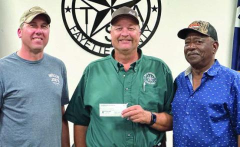 Schulenburg Economic Development Corporation President Paddy Magliolo (left) and Treasurer Ed Glass (right) present a $220,000 check to City Operations Manager Darryl Moeller. The funds will go toward paving at the Civic Center as well as on Matula, Kueper, and Avenue and B ($70,000) along with sewer line relocation and line replacement on College Street ($150,000.