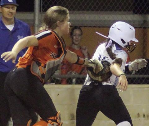 Catcher Hailey Kahlden tags out an Indianette after receiving shortstop Haylie Goode’s relay throw from the outfield. Sticker Photo By Darrell Vyvjala