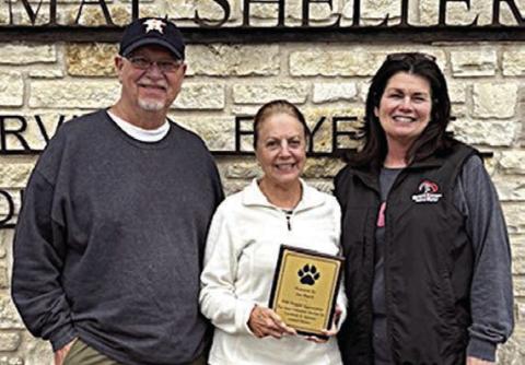 The Gardenia E. Janssen Animal Shelt er recognized Ann Rauch (center) for six years of service as a director. Making the presentation were Frank Reichert, (left) board president, and Teresa Brown (right), executive director.