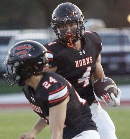 Mason Kunschick (No. 24) prepares to throw a block to spring Jayse Janda on a 17-yard run in the first quarter. Sticker Photo By Layne Vyvjala