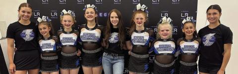 Blue Light ning elite all-star cheer team and coaches include (from left) Addisan Wagner-assistant coach, Lexi Pilat, Lennon Demel, Ava Baladez, Emily Garza-head coach, Paisley Baladez, Brooklyn Beeman, Bebe Pavlica and Avalon Saavedra-assistant coach. The Baladez sisters attend Schulenburg ISD. Sticker Photo By Diane Prause