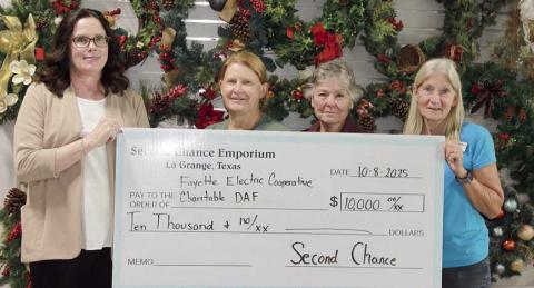 HolDiNG A $10,000 DoNAtioN cHeck from table Donor Advised Fund are (from left) Tracy Denton, FEC director of marketing, communications and training; Marlene Schnell, SCE assistant store director; Darlene Strahan, SCE assistant store director; and Gayle Schielack, SCE store director. The funds will help continue providing free books to children in Fayette County through Dolly Parton’s Imagination Library. Holding a $10,000 dona tion check from Second Chance Emporium to the Fayette Electric Cooperative Chari-