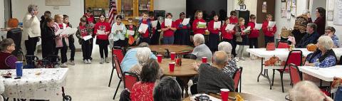 St. Rose students (standing in back) performed jokes, skits and songs for the Senior Connections Thanksgiving luncheon on Wednesday, Nov. 16.