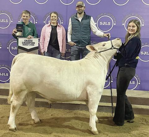 STEER – Exhibitor: Madyson Holub (right). Sales price: $12,000. Sticker Photo By Darrell Vyvjala