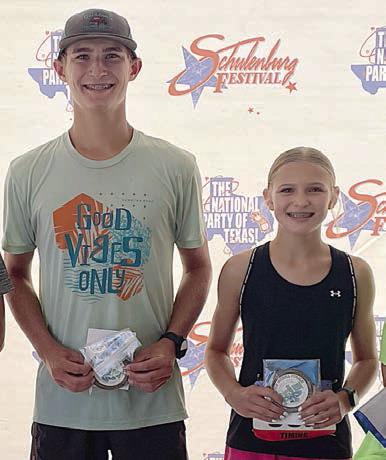 Overall 5K winners – (from left) Ty Lewis and Avery Lewis. Sticker Photo By Darrell Vyvjala