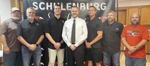 Welcoming Dr. Jerrod Barton (center) after his hiring as the new secondary principal last Wednesday are: (from left) Schulenburg ISD Board of Trustees President Mike Zweschper, Superintendent Lee Hafley, Trustee Hale Hentges; (from right) trustees Jarrod Schramek, Joel Blansitt, and Shannon Hollas. Sticker Photo By Darrell Vyvjala