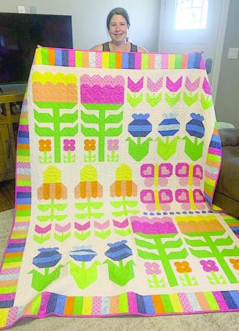Steve Kana from Schulenburg was the 2026 winner of the drawing for a quilt at the Colorado Valley Quilt Guild’s “Best Little Quilt Show in Texas,” held on Friday and Saturday, Feb. 27-28 at the KC Hall in La Grange. Carol Kana pictured with the “Flower Power” quilt.