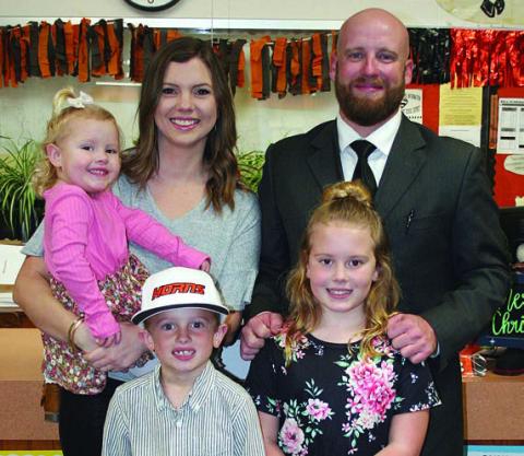 On hand at Monday night’s school board meeting to accept the SISD athletic director position was Luke Hobbs with his wife, Savannah, and children (from left) Sadie, Shane, and Presley. Sticker Photo By Darrell Vyvjala