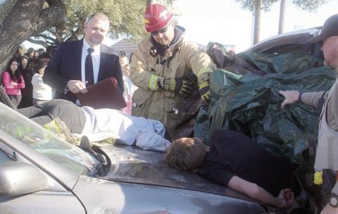 Fayette County Precinct 4 Justice of the Peace Paul Zapalac (left) conducts an inquest, resulting in the death pronouncements for the two ejected accident victims. Assisting him at the mock scene were Schulenburg Volunteer Fire Department First Assistant Chief Drew Brossmann (center) and Fayette County Sheriff’s Department Deputy Rick Bohlmann (right). Sticker Photo By Darrell Vyvjala
