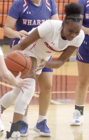 Jashiya Jackson comes up with a loose ball against Wharton. Sticker Photo By Darrell Vyvjala
