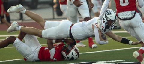 Owen Brenek runs over a Panther to finish off a 12-yard run in the first quarter. Sticker Photo By Layne Vyvjala